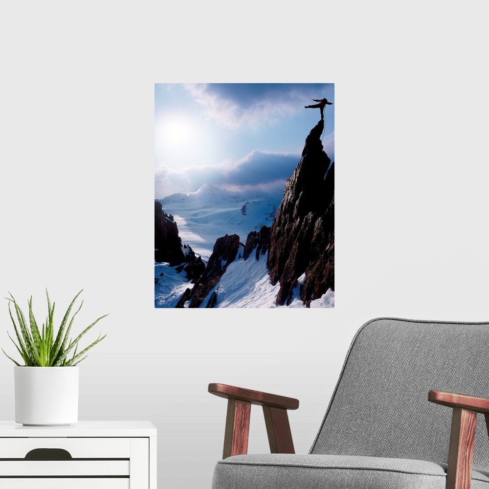 A modern room featuring Rock climber at the peak of a snow capped mountain