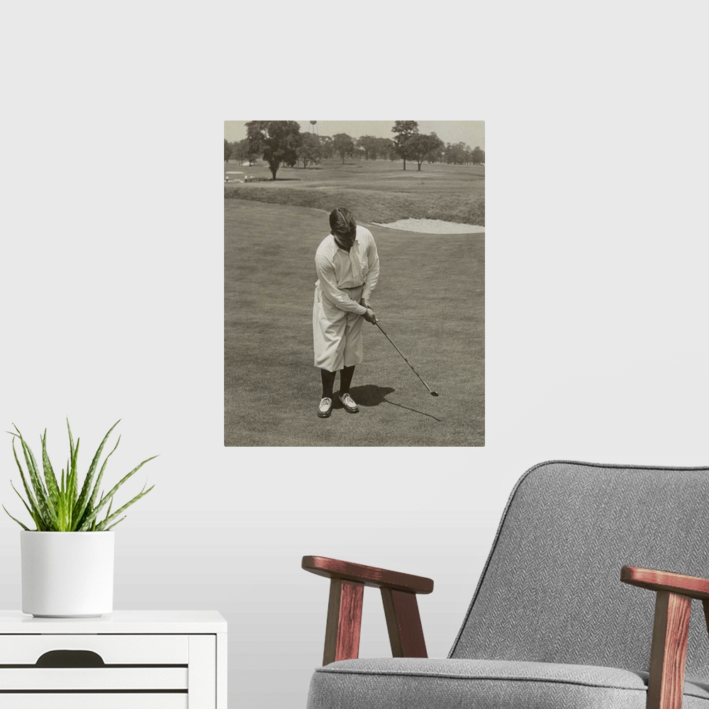 A modern room featuring Bobby Jones, winner of 1929 National Open Golf Championship. He is sinking a putt with his famous...