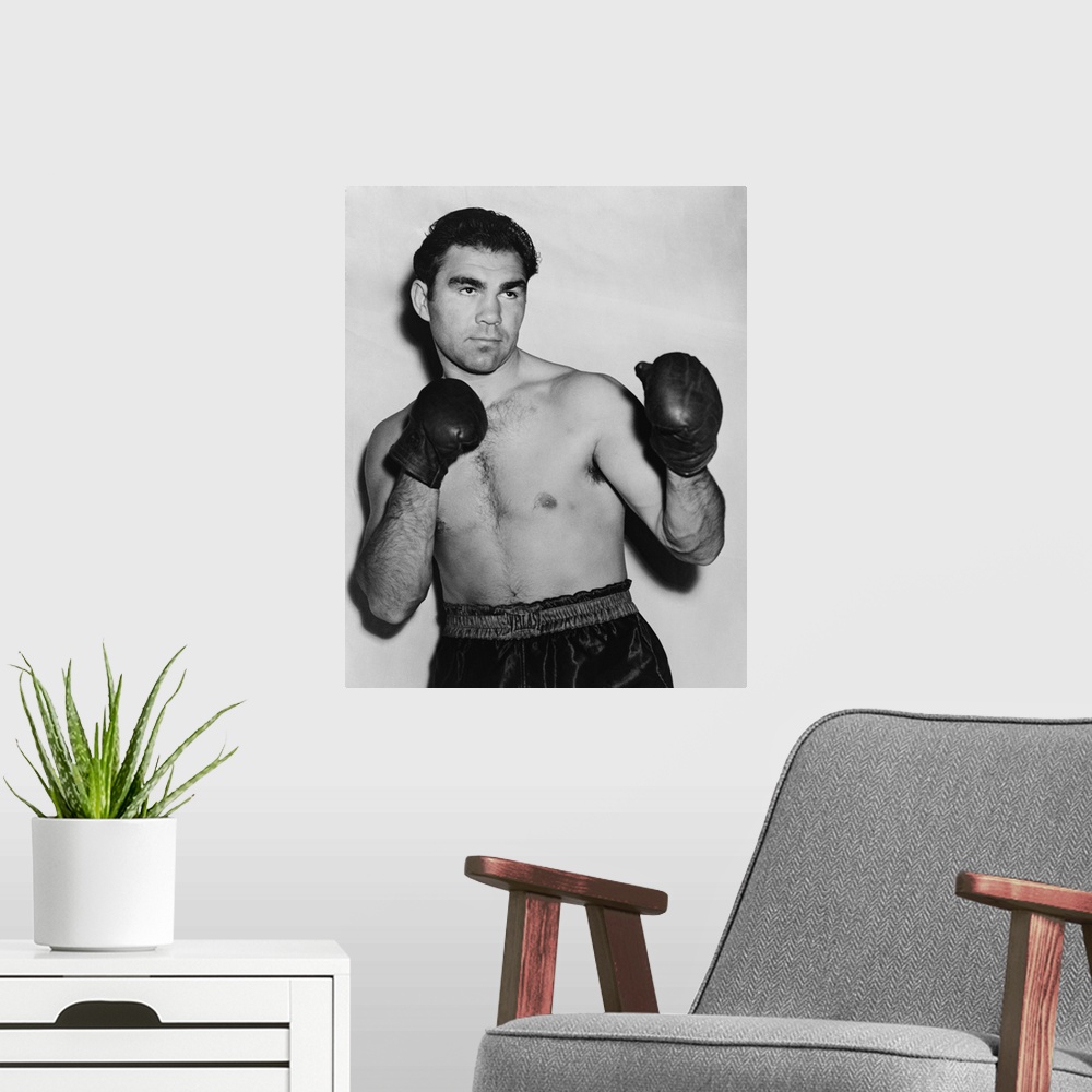 A modern room featuring German boxer Max Schmeling in a boxing pose in 1938. On June 22, 1938 he lost in a rematch with A...