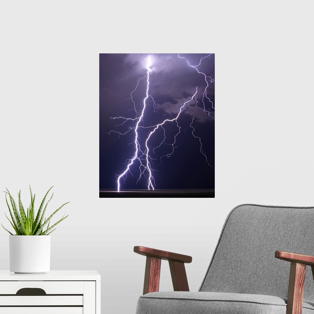 A modern room featuring Multiple cloud to ground lightning strikes fill frame on this shot of summer night's storm over p...