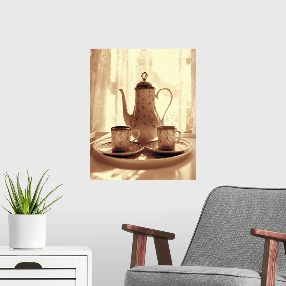 A modern room featuring Still life of teapot and cups on tray by window