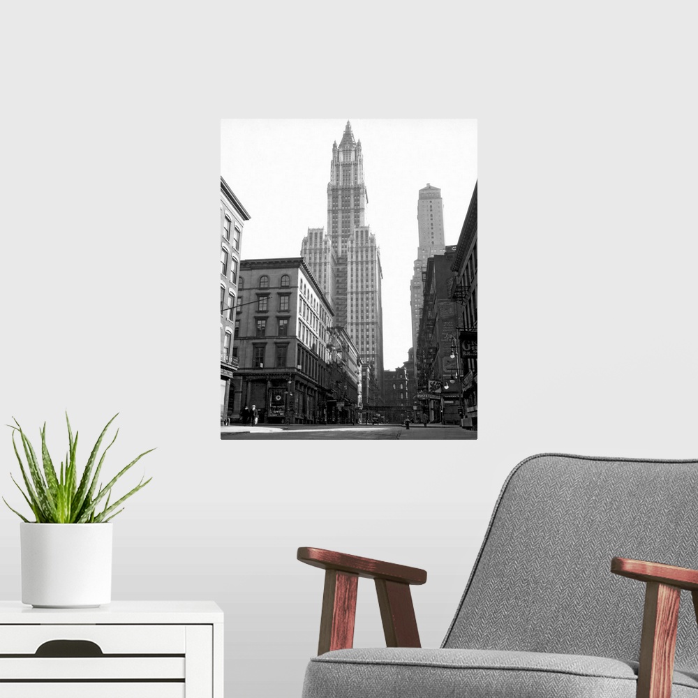A modern room featuring Black and white photograph of a skyscraper in New York City that towers over others surrounding it.