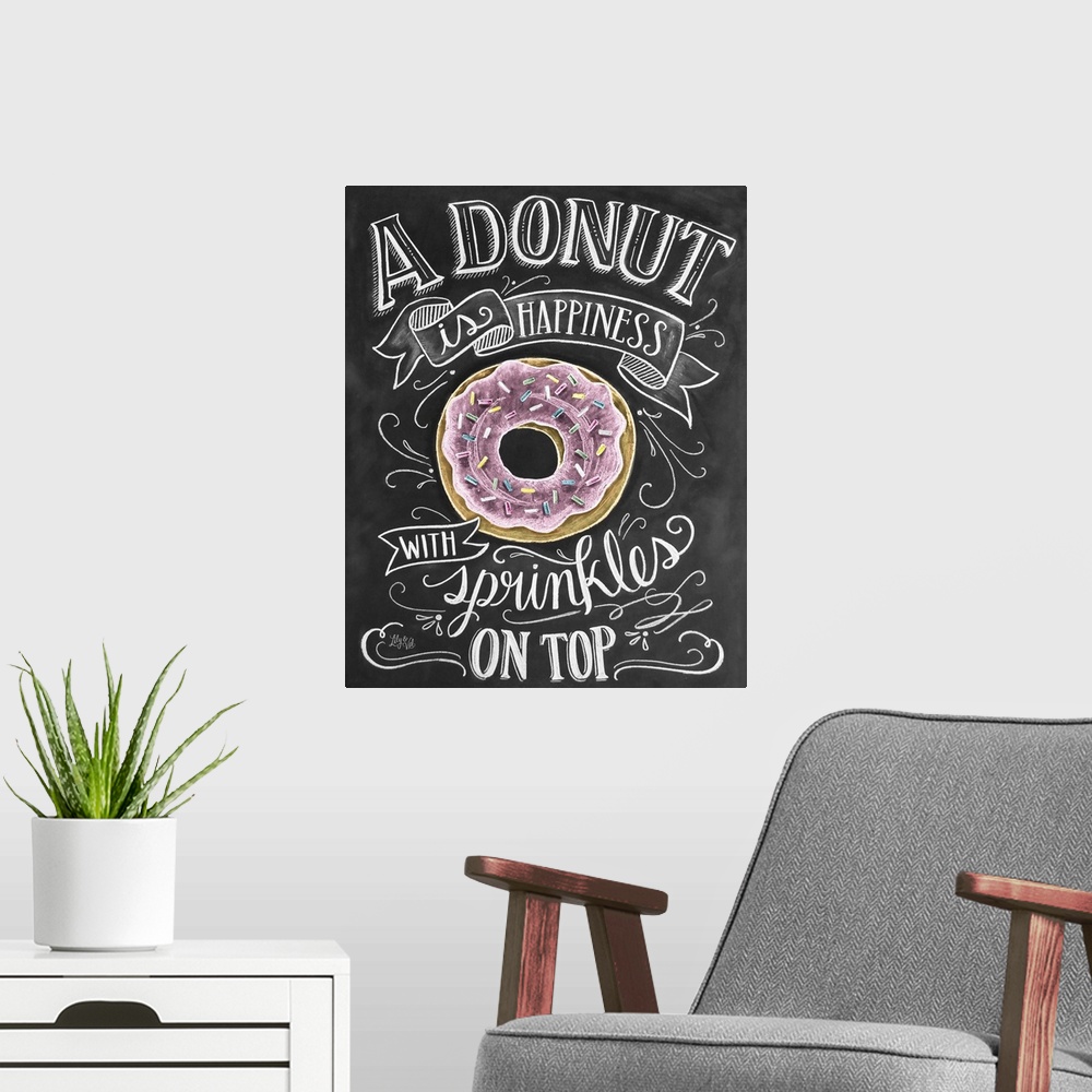 A modern room featuring "A donut is happiness with sprinkles on top" handwritten in white chalk with a drawing of a donut.