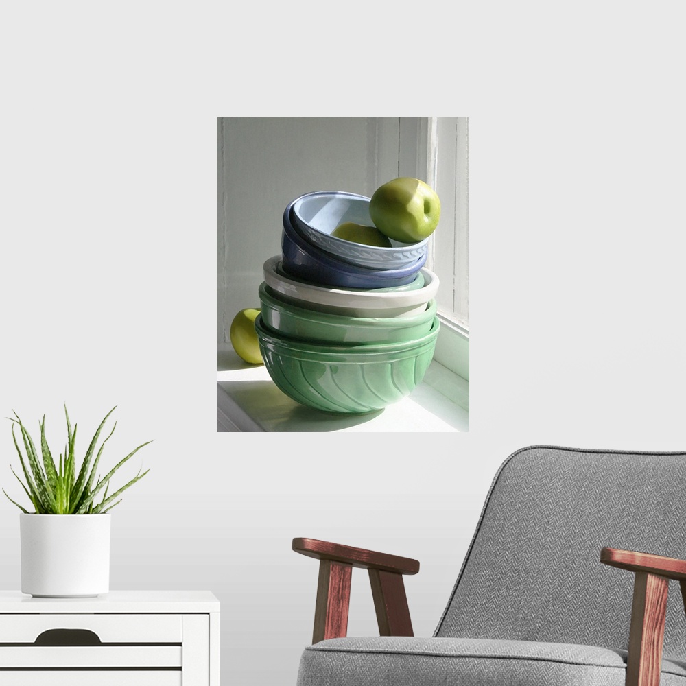 A modern room featuring A stack of ceramic bowls with green apples on a windowsill.