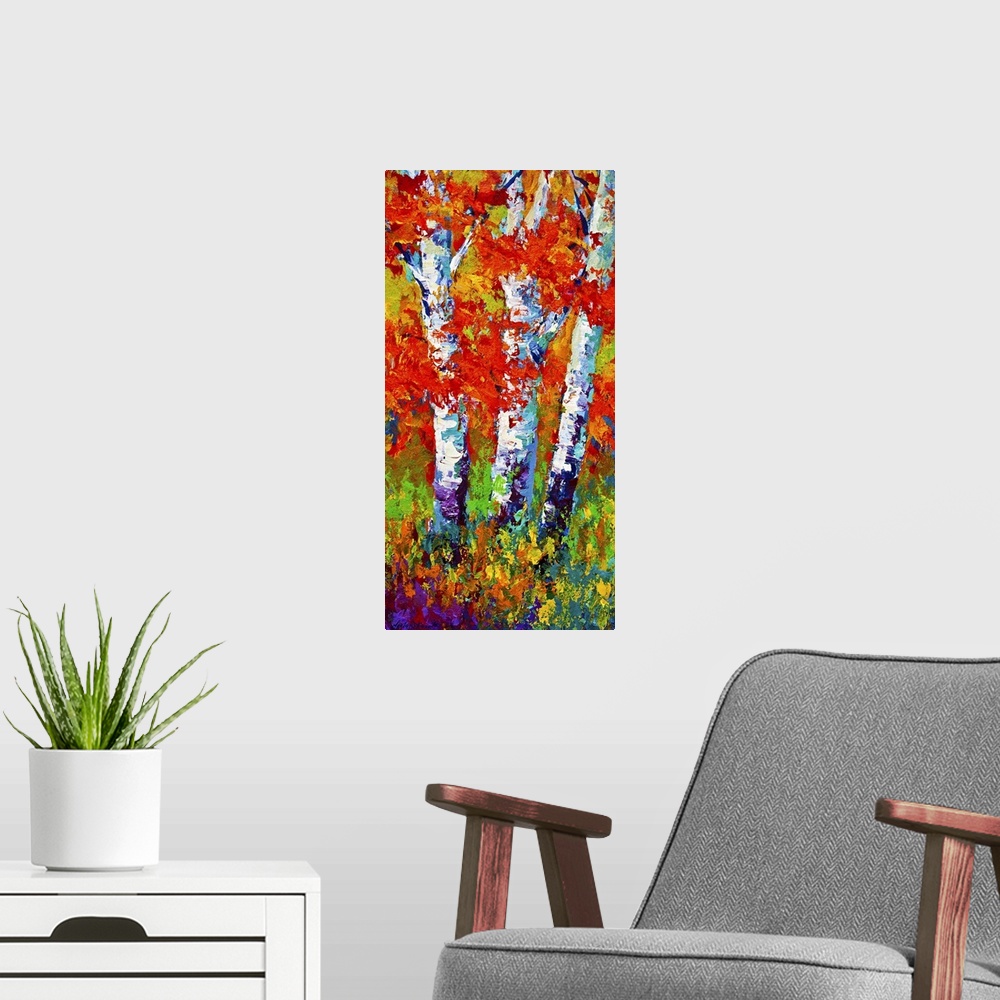 A modern room featuring Vertical painting on a big canvas of several birch trees surrounded by vibrant fall leaves and gr...