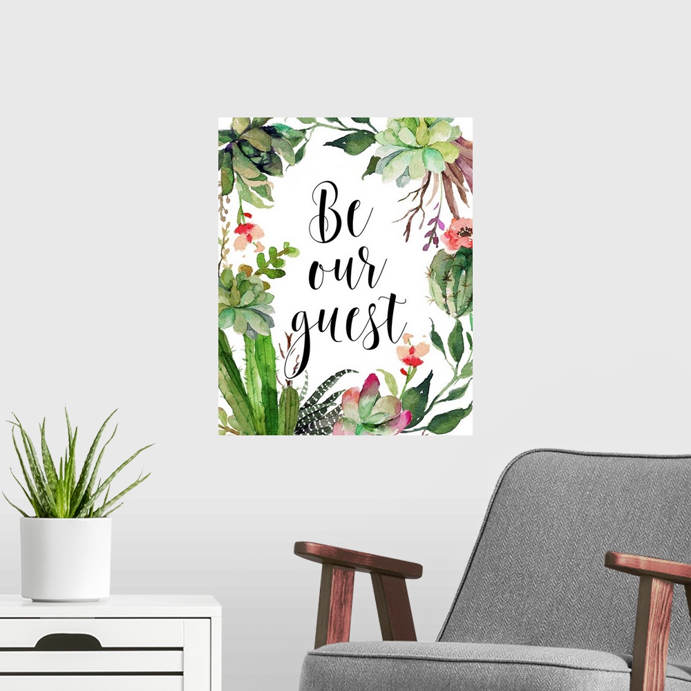A modern room featuring A beautiful watercolor painted wreath with the phrase "Be Our Guest" written in the middle in black.