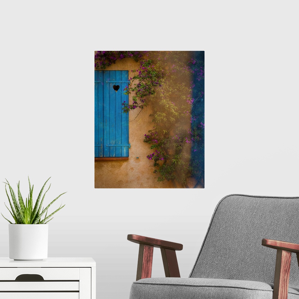 A modern room featuring Photograph of a French facade with a window and blue wooden shutters framed by a vine with little...