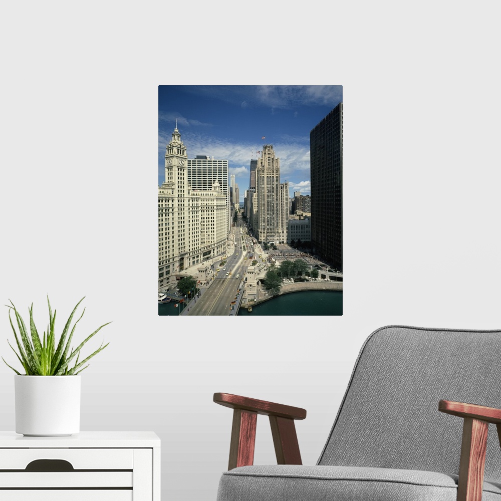 A modern room featuring A large vertical piece of a bridge and street running through tall buildings in the city of Chicago.