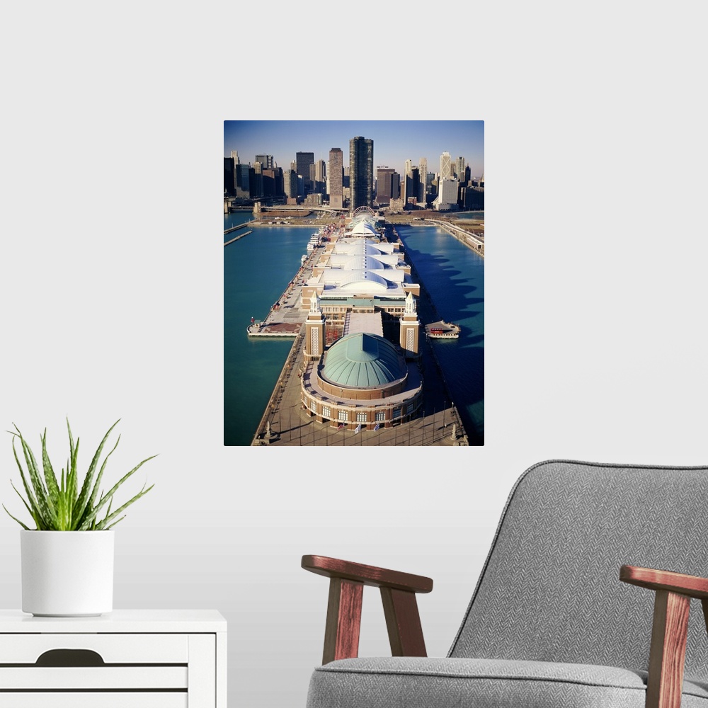 A modern room featuring A vertical photograph of a pier that juts out into Lake Michigan with a large pavilion built on t...