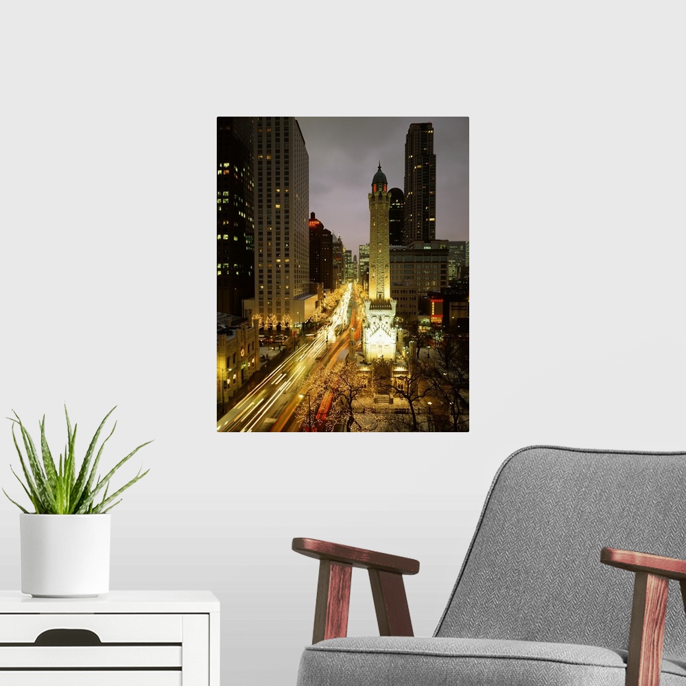 A modern room featuring Huge photograph looks down a busy avenue flooded with people and cars, while a variety of tall bu...