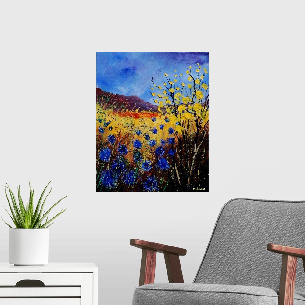 A modern room featuring Contemporary painting of a field of cornflowers in blue, yellow and orange.