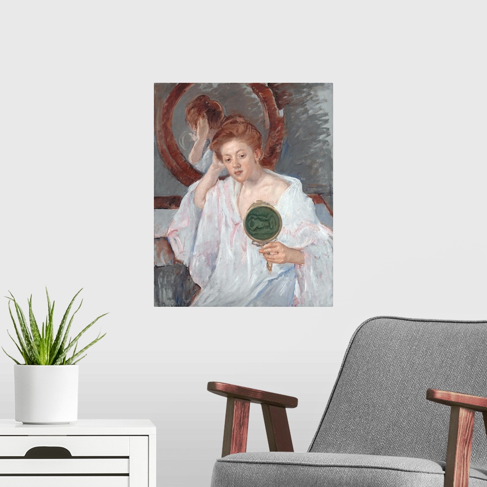 A modern room featuring Holding a hand mirror backed with green moire, a pretty auburn-haired young woman-apparently a pr...