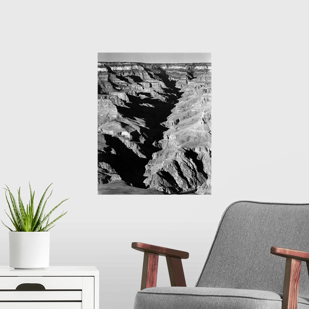 A modern room featuring Grand Canyon from South. Rim, 1941,vertical panorama with shadowed ravine.