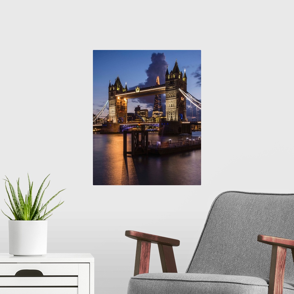 A modern room featuring Photograph of Tower Bridge over River Thames with the Shard Building in the background, all lit u...