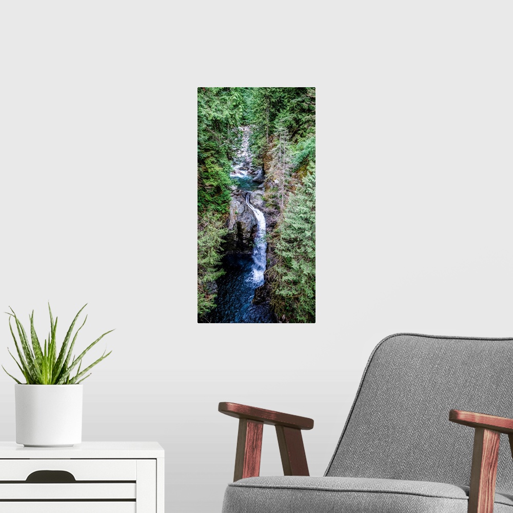A modern room featuring View of waterfall under Capilano Suspension Bridge in North Vancouver, British Columbia, Canada.