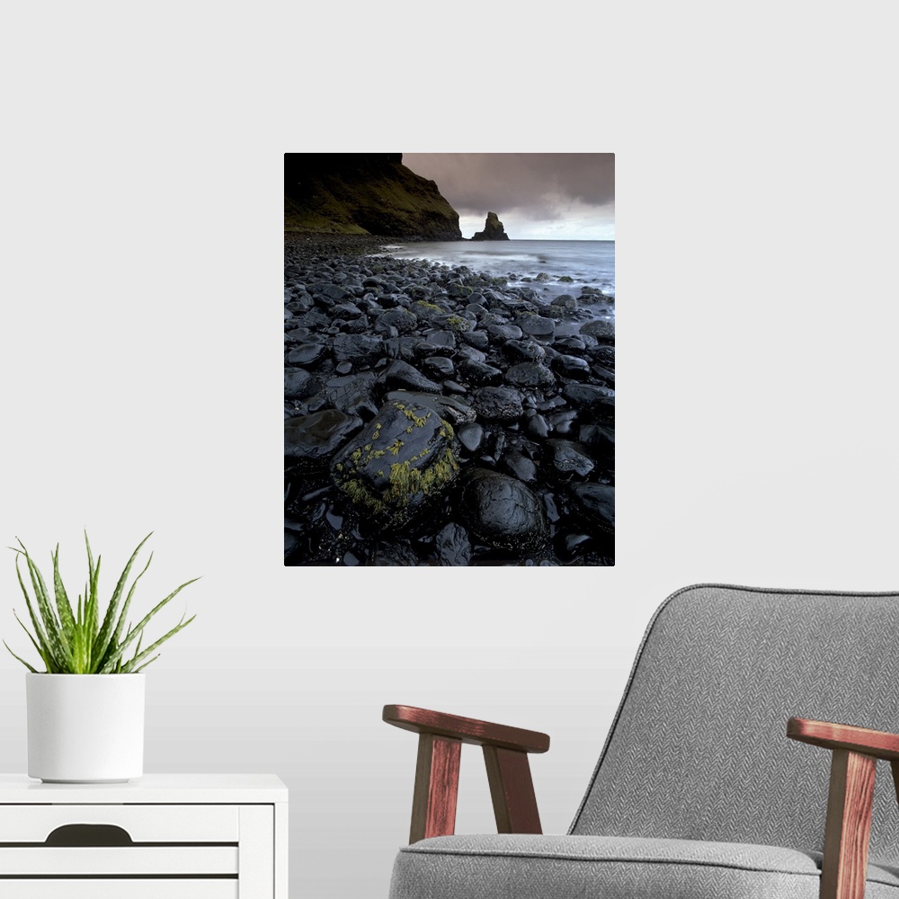 A modern room featuring Black boulder rocks in Talisker Bay, Isle of Skye, Inner Hebrides, Scotland, UK