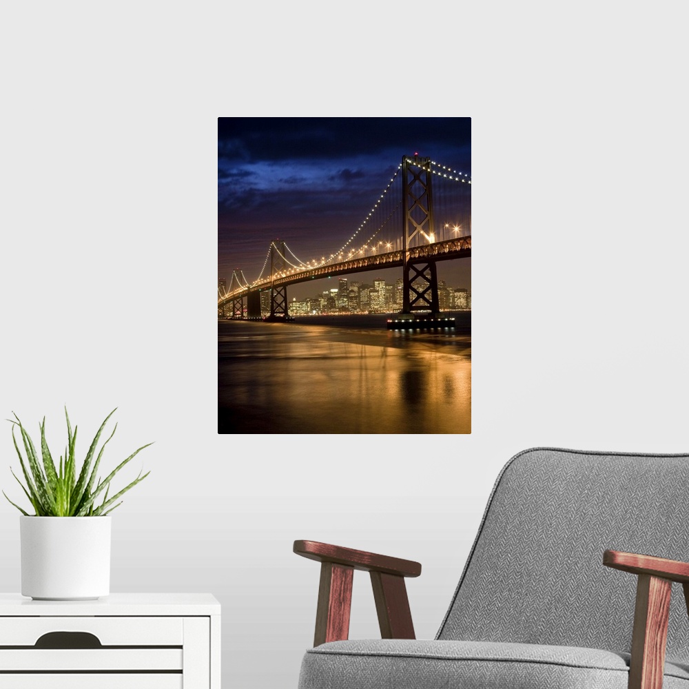 A modern room featuring Oakland Bay Bridge and San Francisco skyline at night