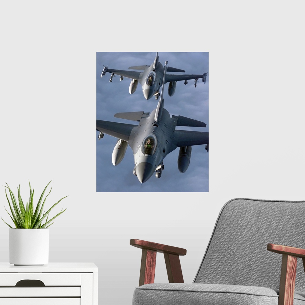 A modern room featuring Two F16 Fighting Falcons fly in formation