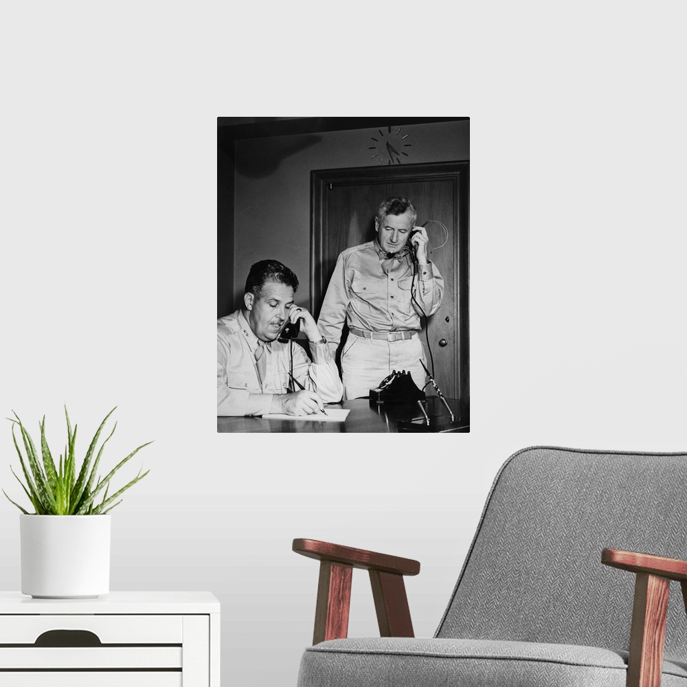 A modern room featuring World War II photograph of General Leslie Groves and General Thomas F. Farrell at work, 1945.