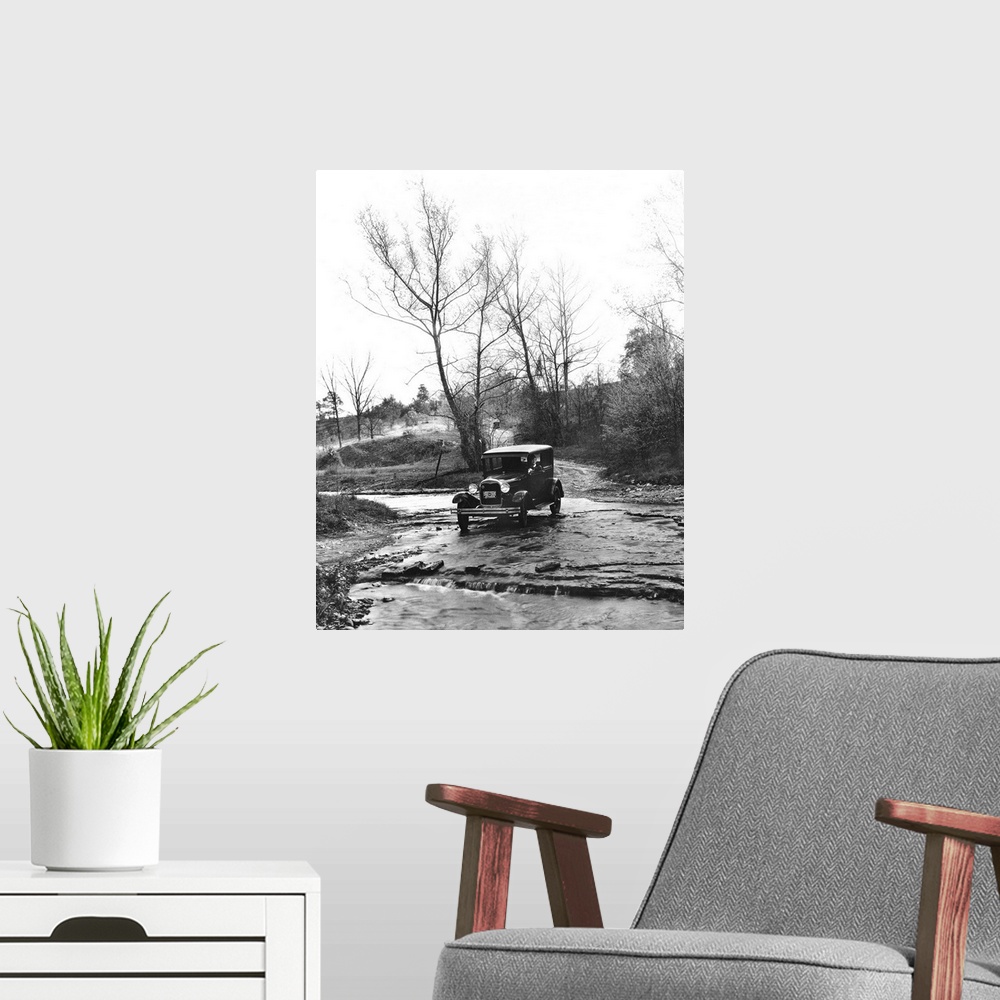 A modern room featuring A Model A Ford crossing a creek bed in Oldham County, Kentucky. Photograph, 1930.