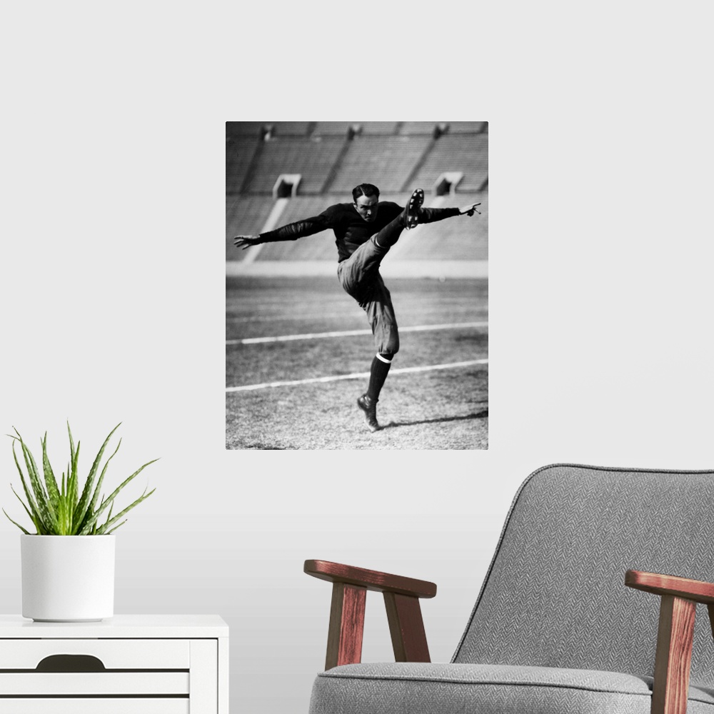 A modern room featuring An unidentified American football player kicking the ball, early 20th century.