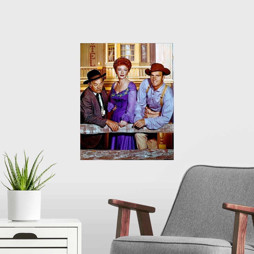 A modern room featuring Cast members Milburn Stone, Amanda Blake, and Dennis Weaver in a publicity photograph for the tel...