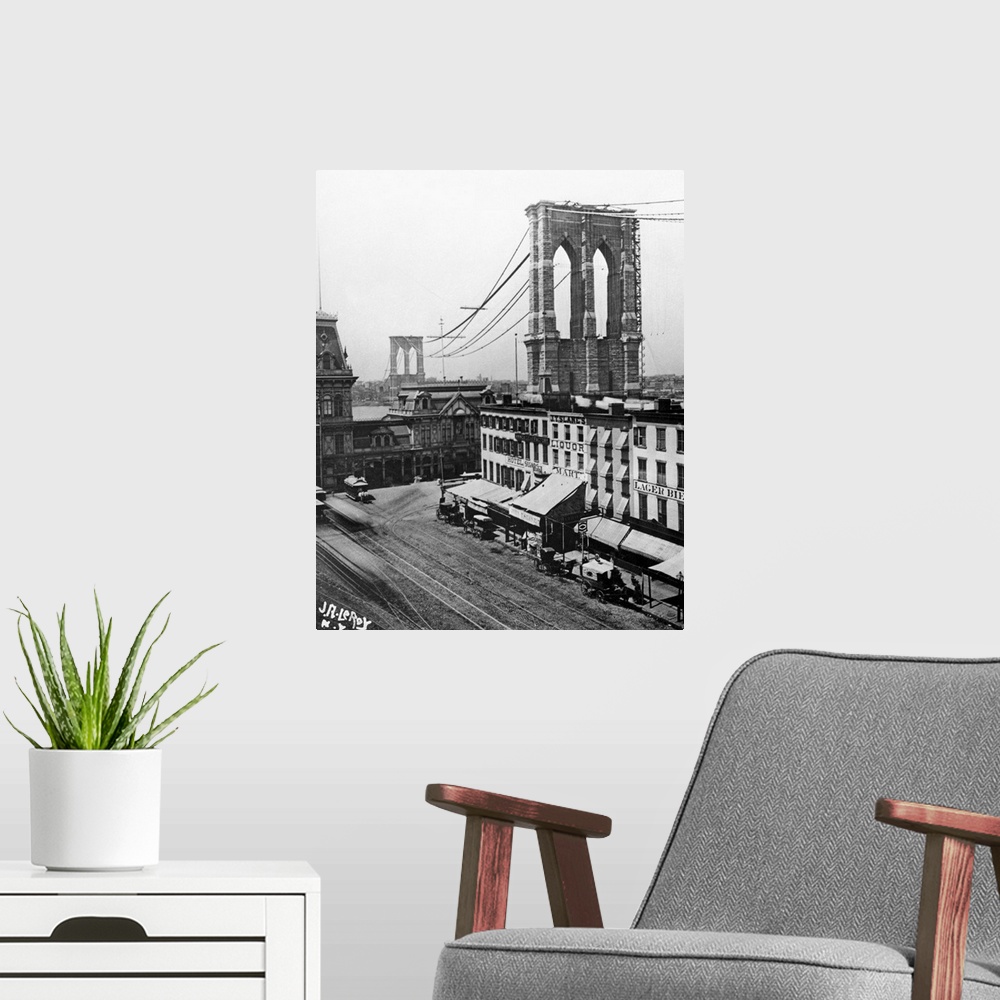 A modern room featuring View from Brooklyn of the Brooklyn Bridge under construction over the East River in New York City...