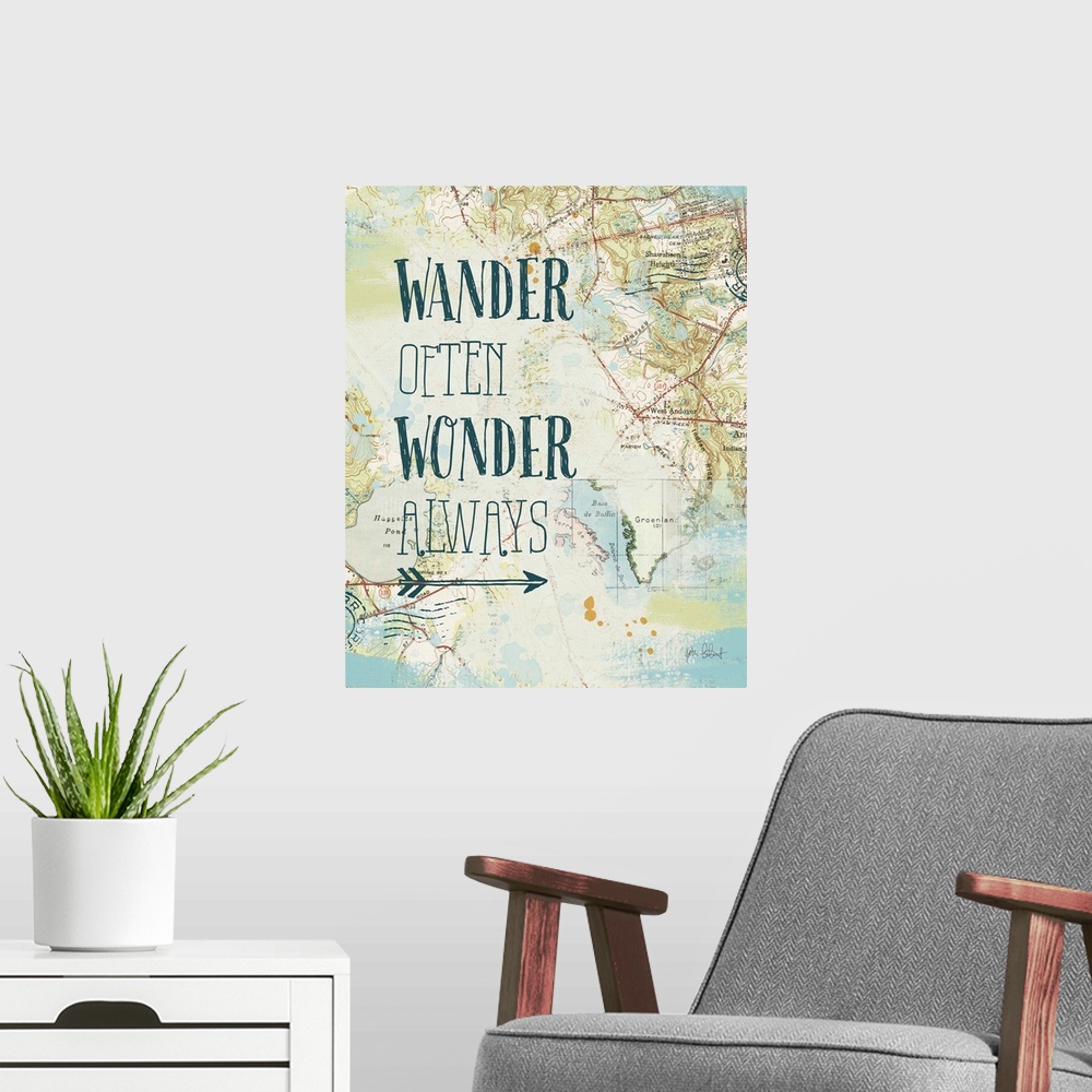 A modern room featuring "Wander Often Wonder Always" written on top of a map and postage stamp collage.