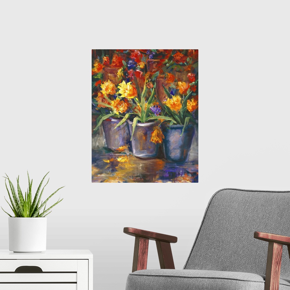 A modern room featuring Still life painting of three vases full of bright flowers.
