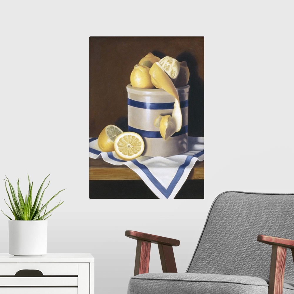 A modern room featuring Contemporary vivid still-life artwork of lemons sitting in a white and blue striped ceramic conta...