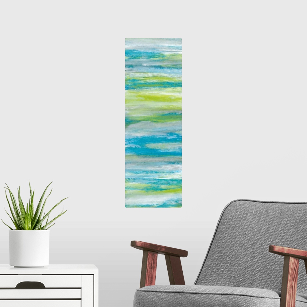 A modern room featuring A long abstract painting of bright textured colors in blue, gray and green.