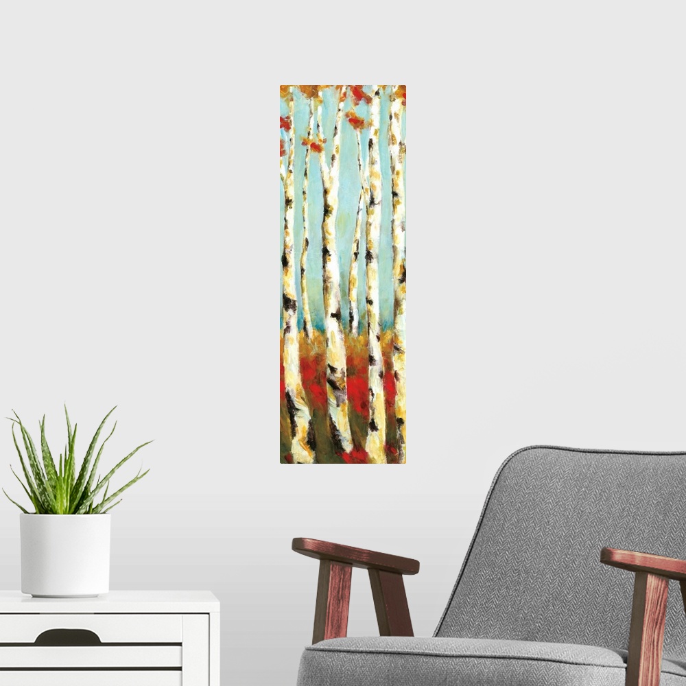 A modern room featuring A long vertical painting of white birch trees with warm colored grass and leaves.