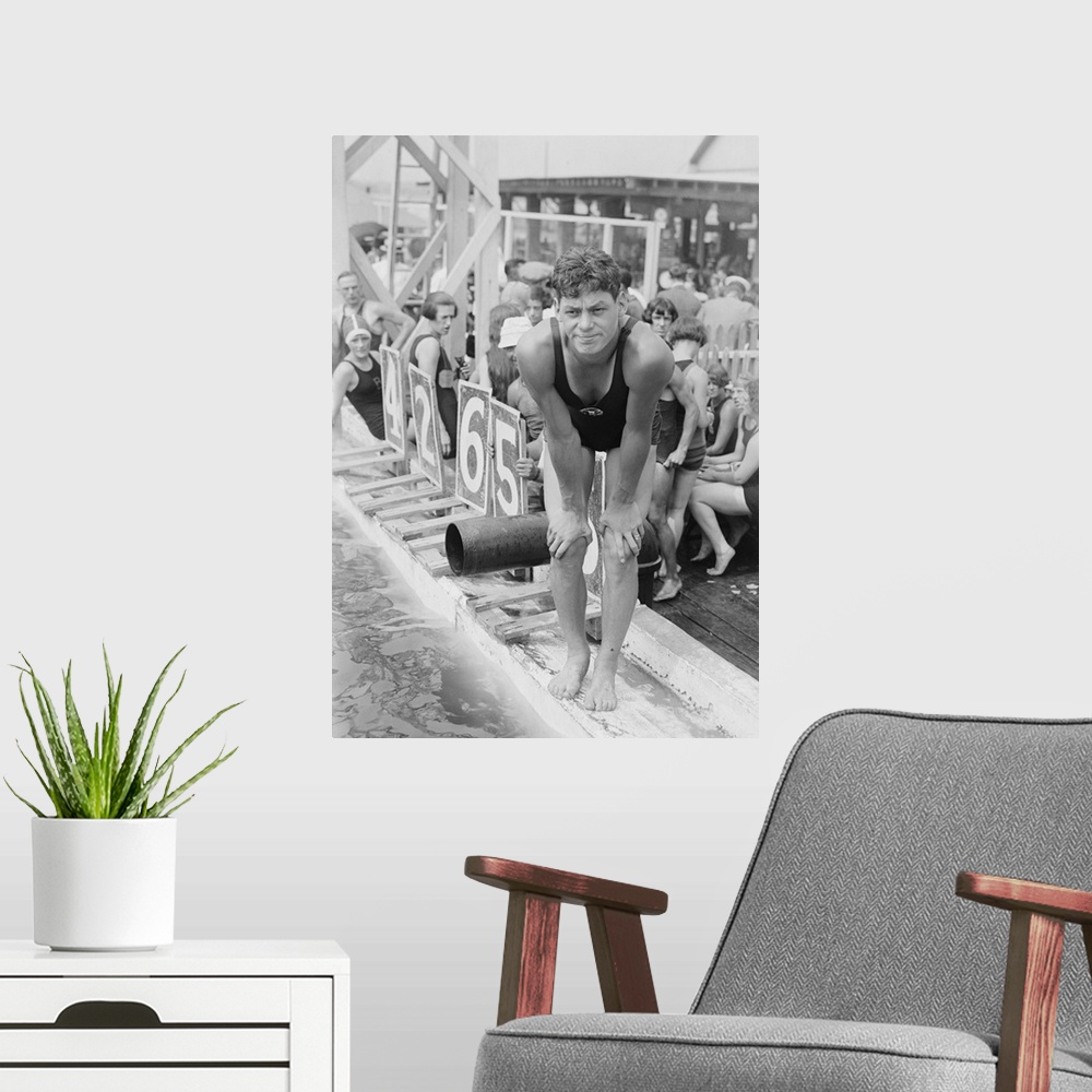 A modern room featuring Johnny Weissmuller at competitive swimming event in the 1920s. After winning five Olympic gold me...
