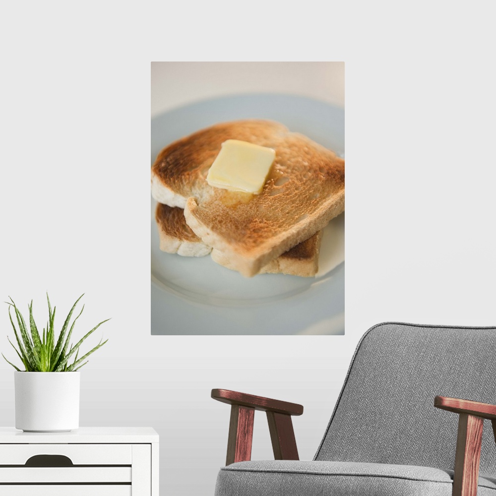 A modern room featuring Close up of toasts with butter on plate