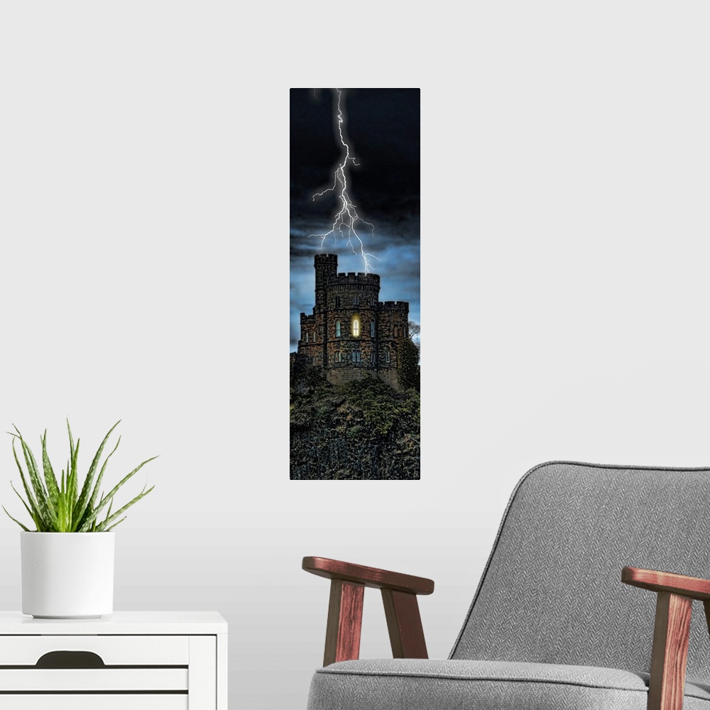 A modern room featuring Giant, vertical photograph of lightening striking a castle on a hill, a single light can be seen ...