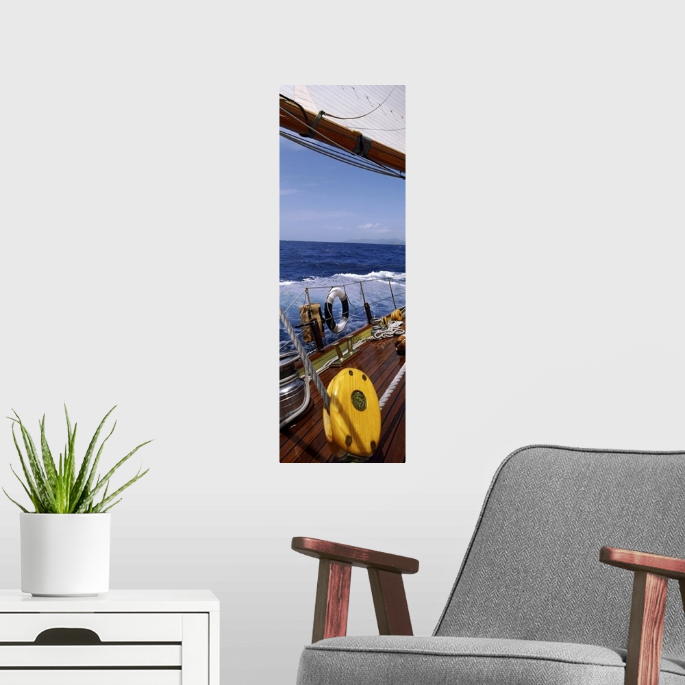 A modern room featuring This photograph is taken on a sailboat showing the detail of the deck on the boat and side railing.