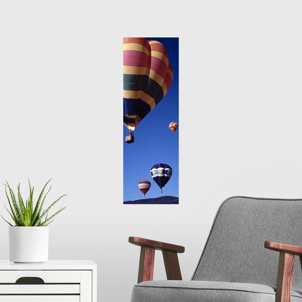 A modern room featuring Low angle view of hot air balloons flying in the sky, Angel Fire, New Mexico