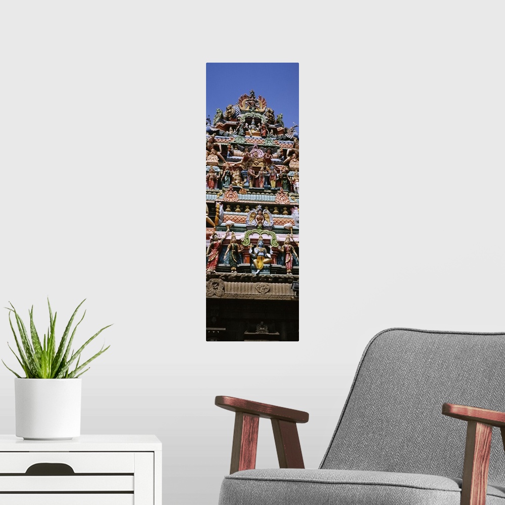 A modern room featuring Low angle view of statues of Hindu gods on the roof of a temple, Arulmigu Kapaleeswarar Temple, C...