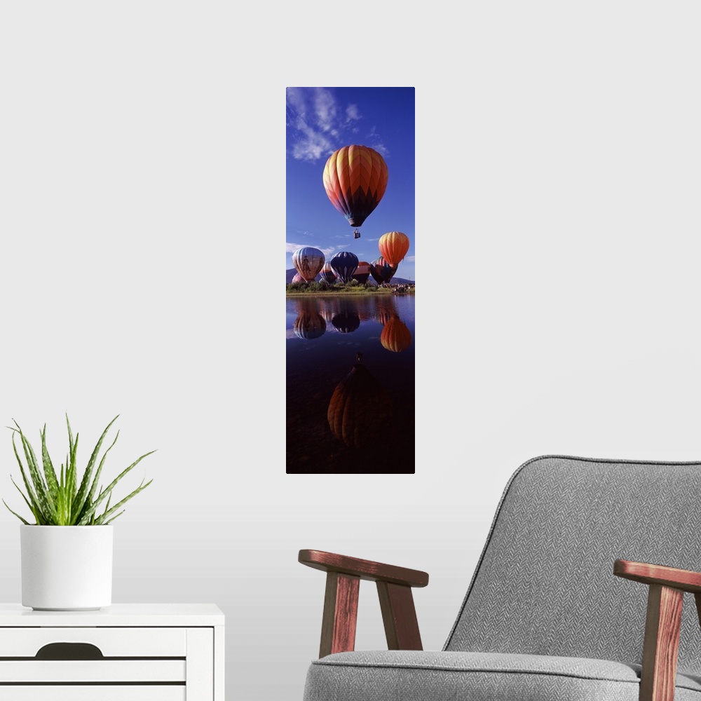 A modern room featuring Reflection of hot air balloons in a lake Hot Air Balloon Rodeo Steamboat Springs Routt County Col...