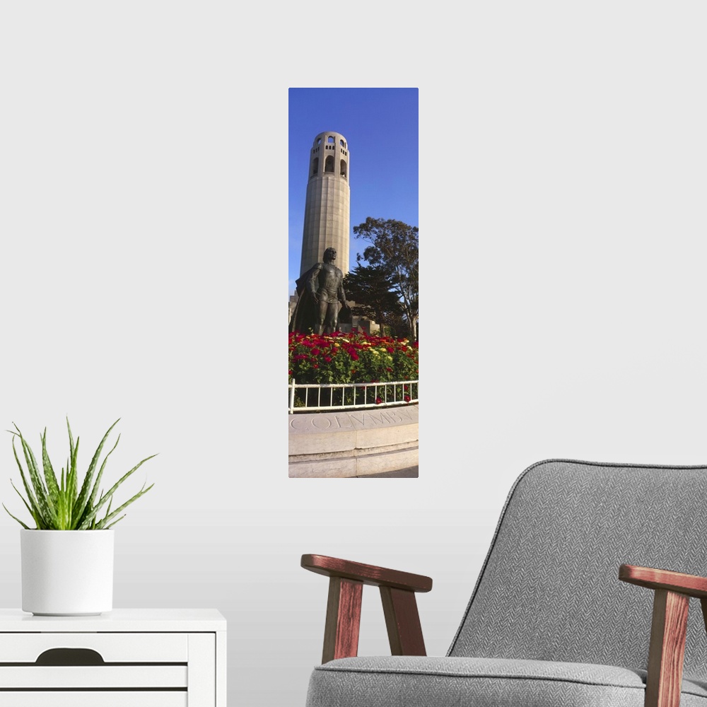 A modern room featuring Statue of Christopher Columbus in front of a tower, Coit Tower, Telegraph Hill, San Francisco, Ca...