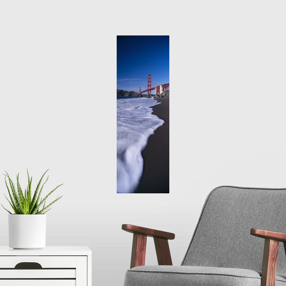 A modern room featuring Large, vertical photograph looking down the shoreline of the San Francisco Bay, the Golden Gate B...