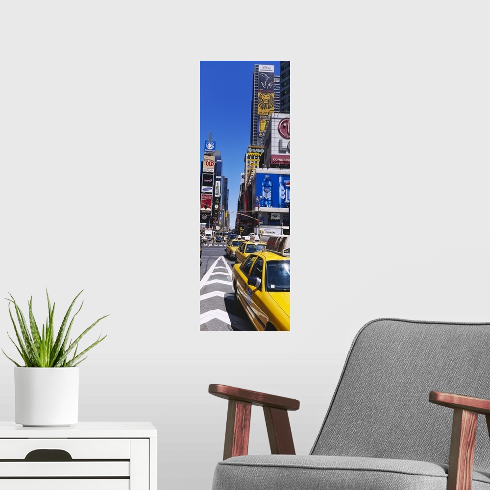 A modern room featuring Vertical panoramic photograph taken of a busy street in Times Square.