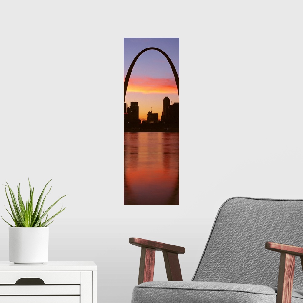 A modern room featuring Vertical photograph on a big canvas of the Gateway Arch over St. Louis, Missouri, at sunrise.
