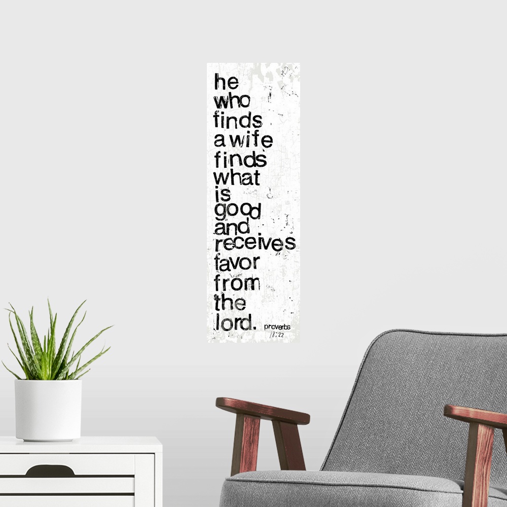 A modern room featuring Distressed black and white letter-stamped Bible verse scripture of Proverbs 18:22 He who finds a ...