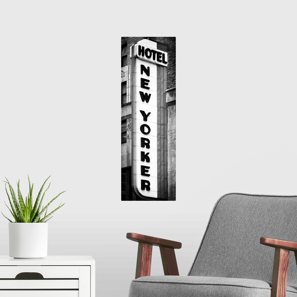 A modern room featuring Black and white photo of the vertical sign for the New Yorker hotel.