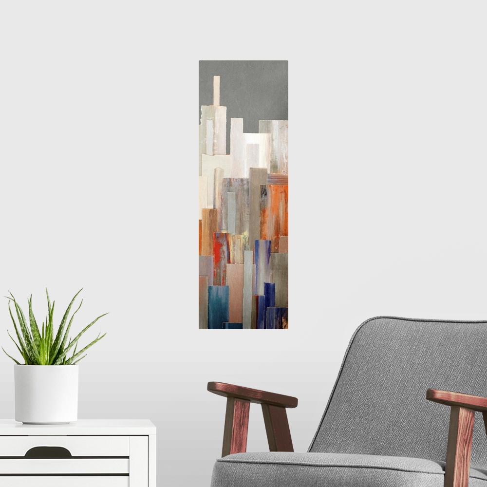 A modern room featuring A long vertical contemporary painting of multi colored buildings in a city.