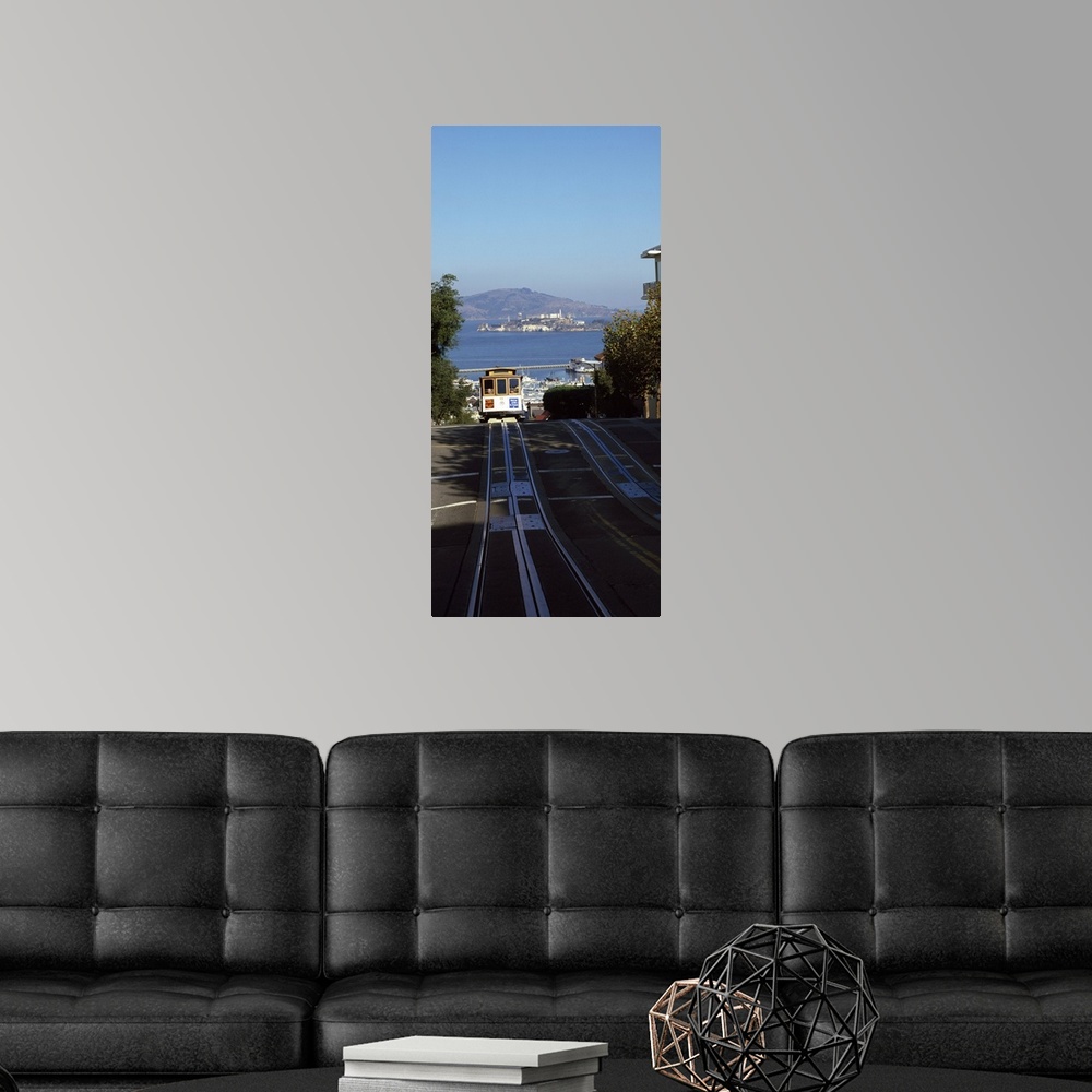A modern room featuring Vertical panoramic photograph of street trolley moving toward the horizon with harbor, waterfront...