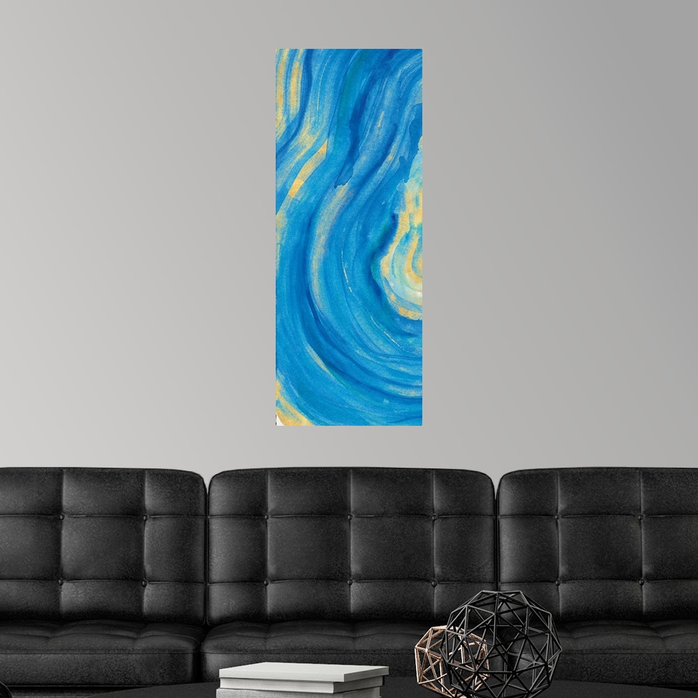 A modern room featuring Tall rectangular painting of the inside of a blue and gold mineral rock.