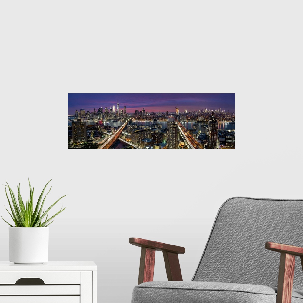 A modern room featuring View over Manhattan and Brooklyn skyline during sunset.