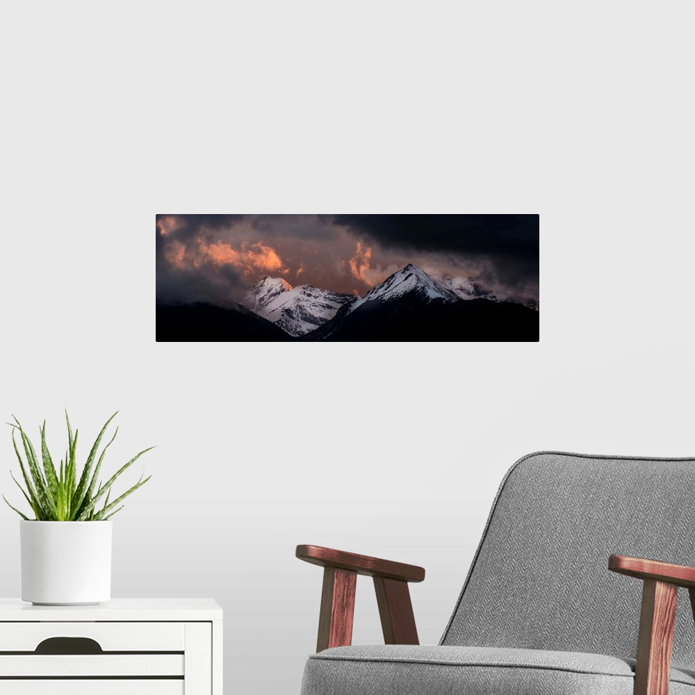 A modern room featuring Landscape photograph of snowy mountain peaks at sunset.